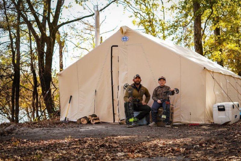 Father and son at their tent
