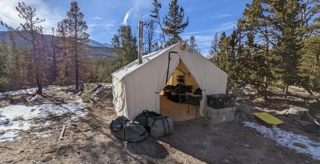 canvas wall tent in the mountains